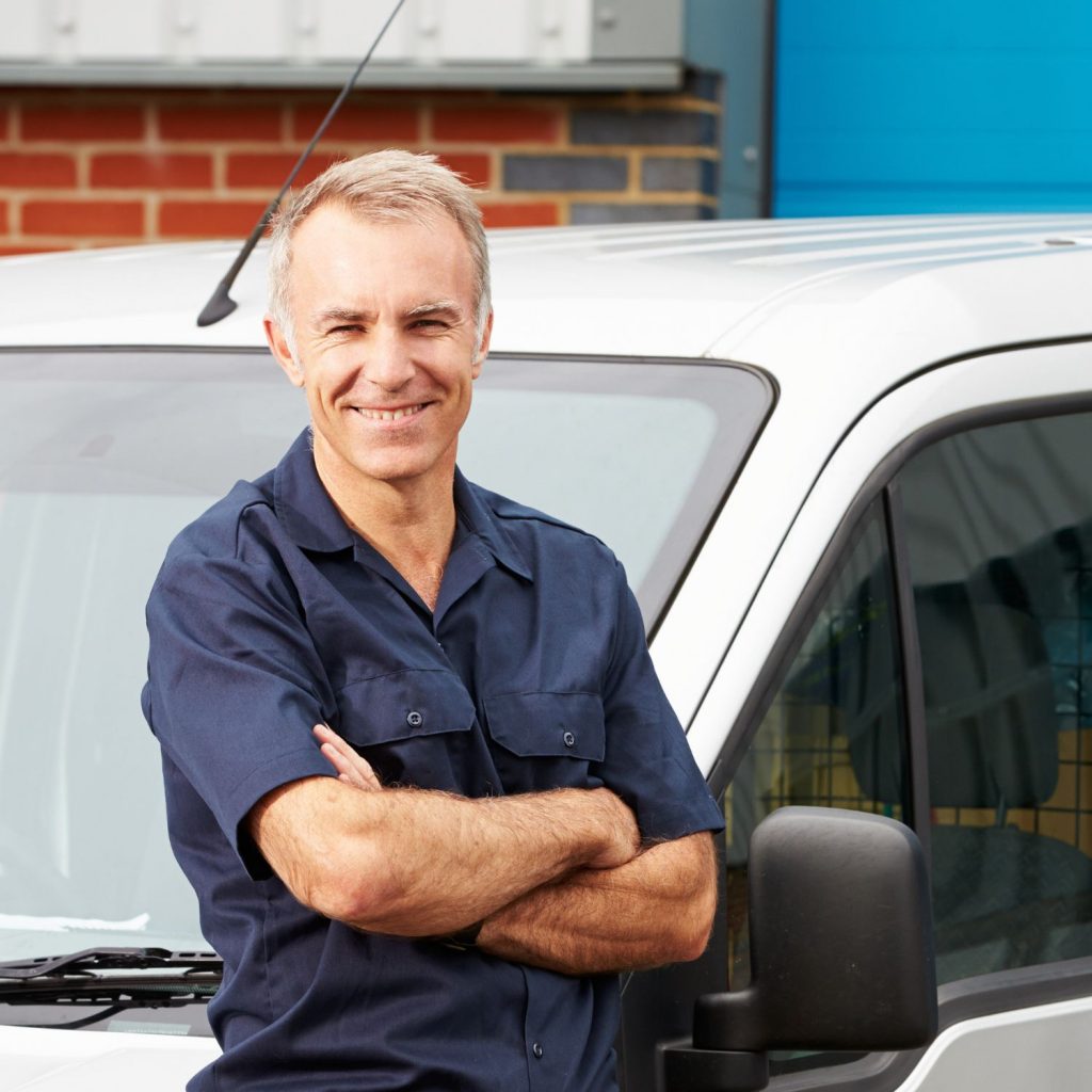 Engineer standing by a van