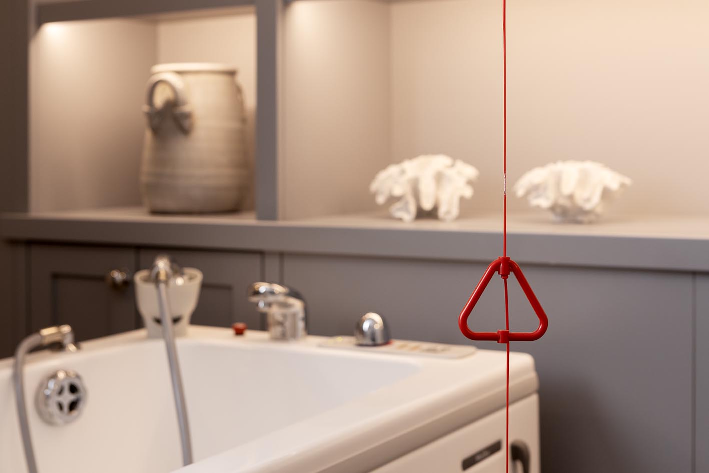 Accessible bathroom pull-cord alarm in care home, part of a nurse call systems installation